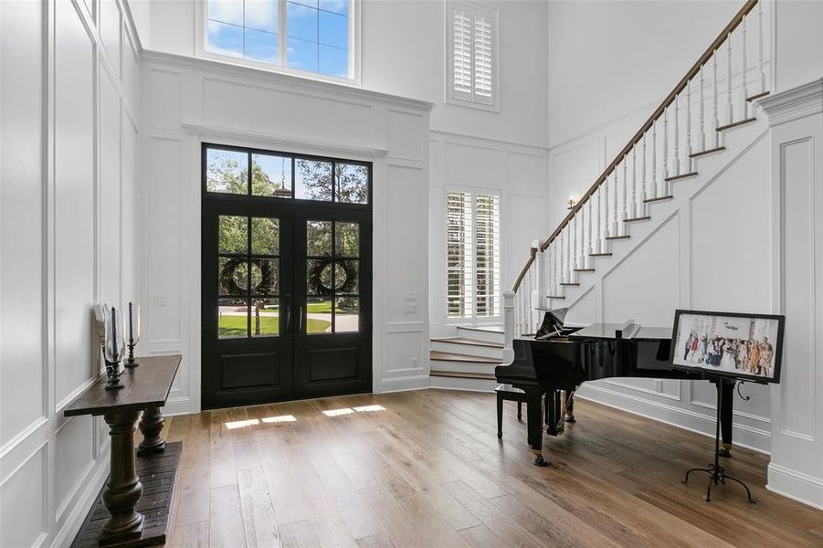 Looking back at the foyer. The spectacular wainscot walls, shutters, engineered wood floors, and all the detailed wood work throughout this house!