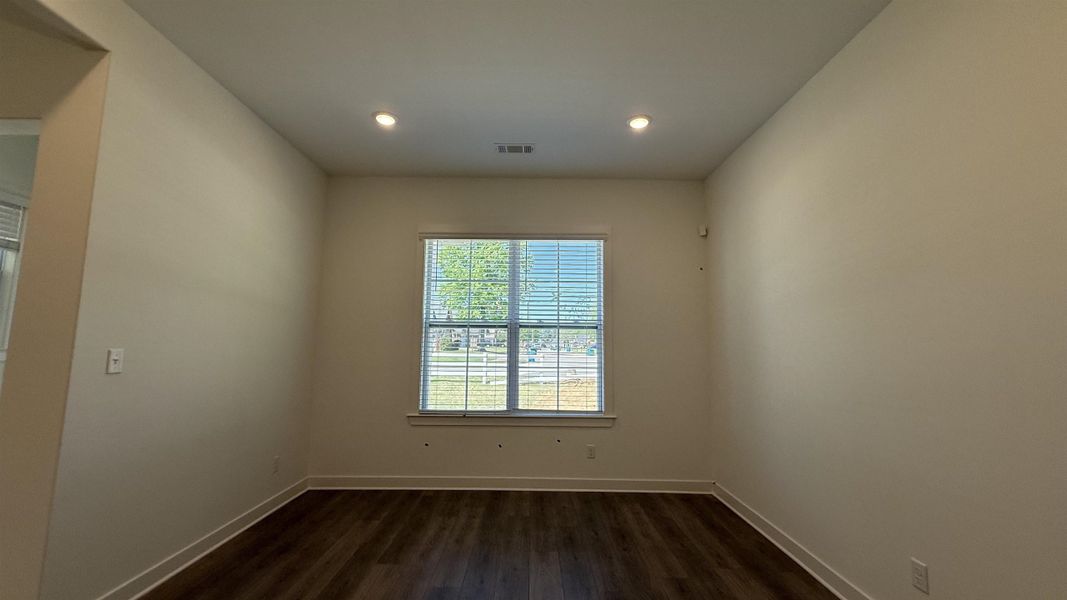 Spare room with dark wood finished floors and recessed lighting