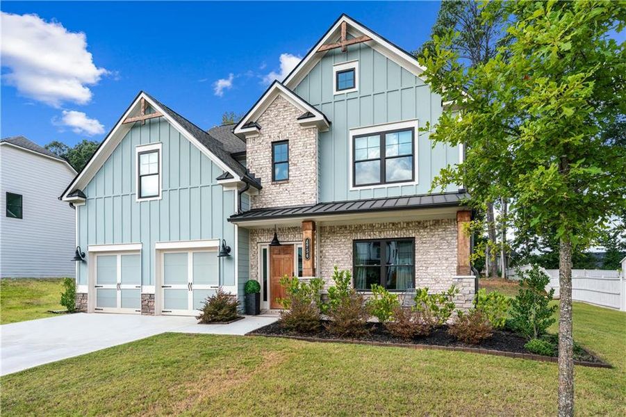 Front exterior of a new home in Springside Reserve, Powder Springs, GA, highlighting curb appeal (Image 25). Front exterior of a new home in Springside Reserve, Powder Springs, GA, highlighting curb appeal (Image 25).