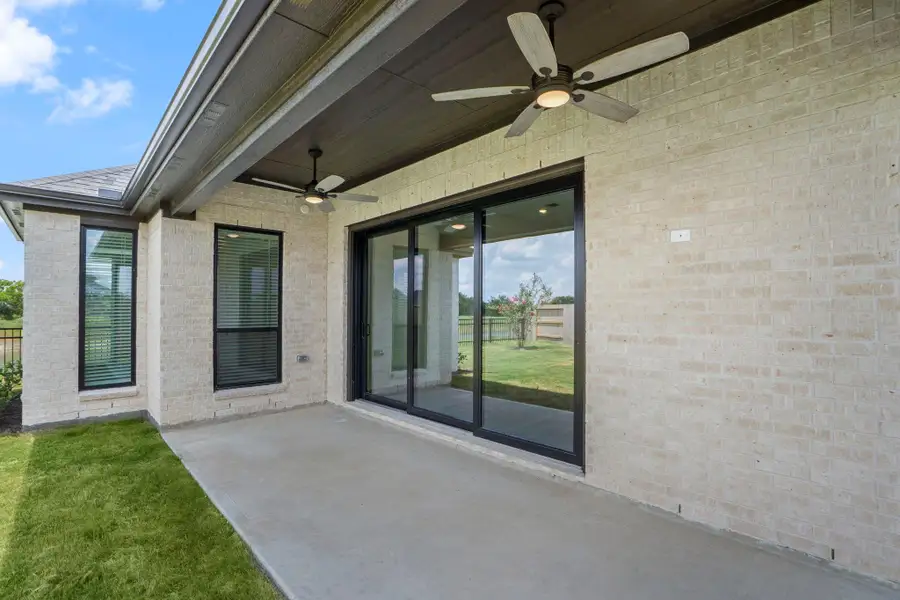 Front exterior of a new home in Valencia, Manvel, TX, highlighting curb appeal (Image 11).