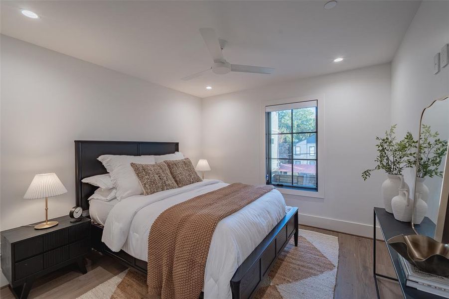 Bedroom with ceiling fan and light wood-type flooring