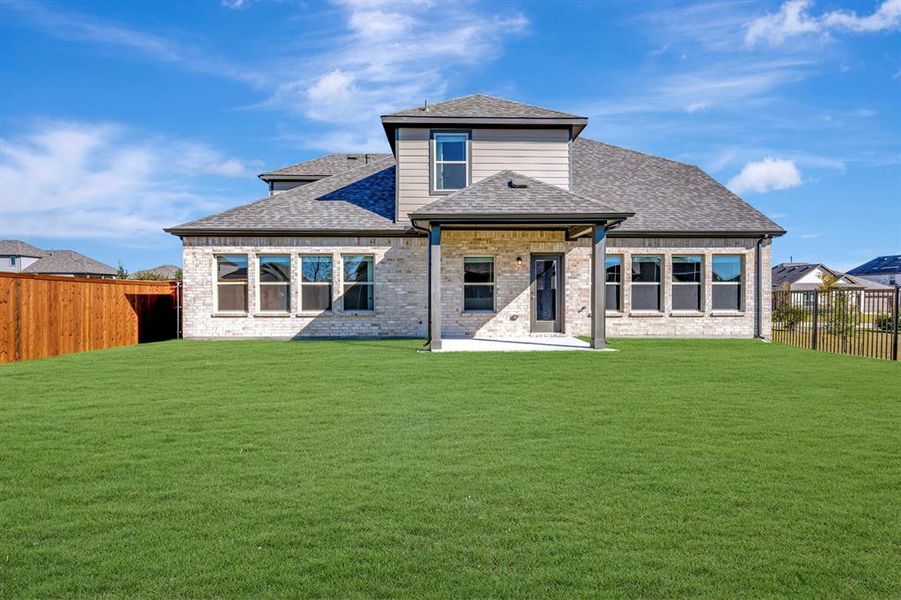 Exterior details and patio area of a home in The Preserve, Justin (Image 1).
