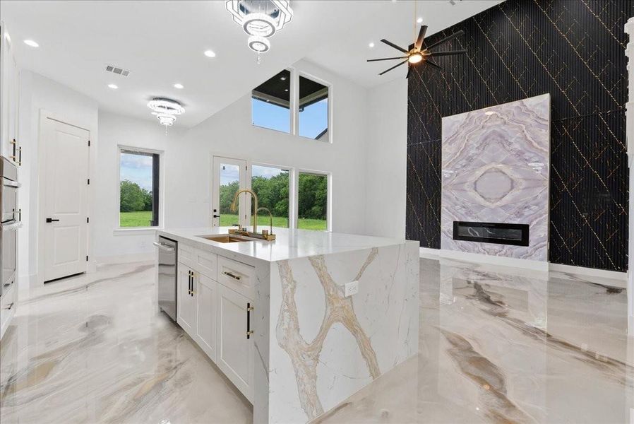 Oversized waterfall island overlooking the dramatic living space.