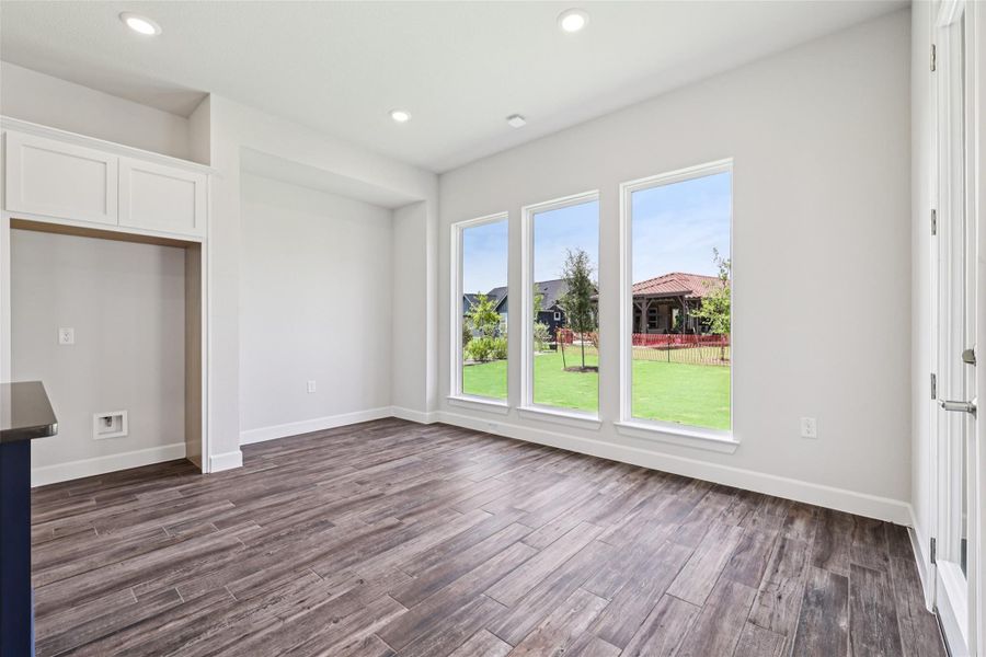 Unfurnished living room featuring dark wood-style flooring and recessed lighting