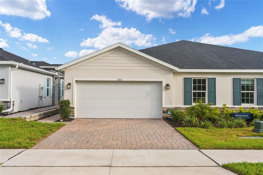 Front exterior of a new home in , Lady Lake, FL, highlighting curb appeal (Image 29). Front exterior of a new home in , Lady Lake, FL, highlighting curb appeal (Image 29).