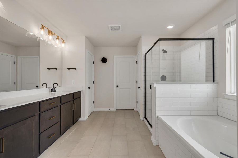 Massive primary bathroom with a full soaker tub and large walk-in shower Massive primary bathroom with a full soaker tub and large walk-in shower