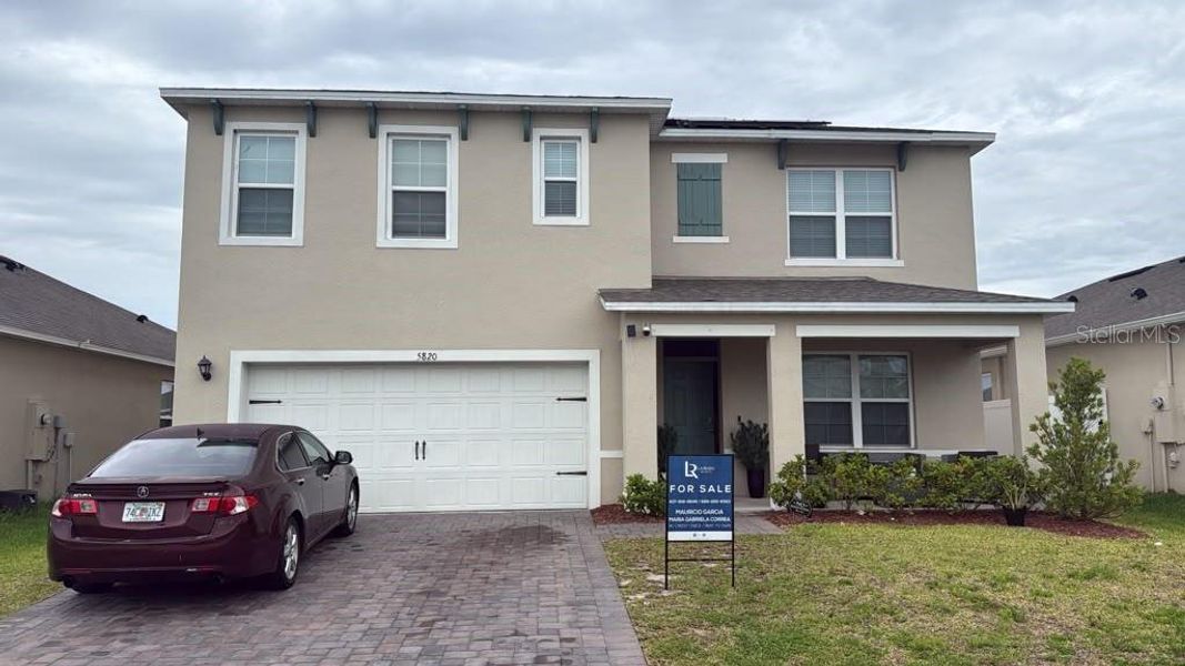 Front exterior of a new home in Prairie Oaks, St. Cloud, FL, highlighting curb appeal (Image 1). Front exterior of a new home in Prairie Oaks, St. Cloud, FL, highlighting curb appeal (Image 1).
