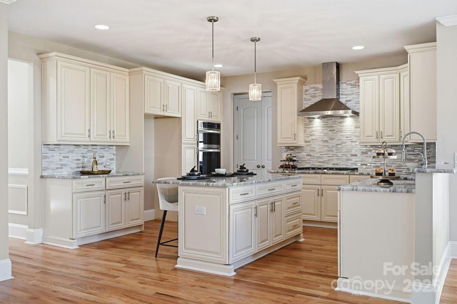 Beautiful gourmet kitchen featuring custom cabinetry, double wall ovens, and a large island. Beautiful gourmet kitchen featuring custom cabinetry, double wall ovens, and a large island.