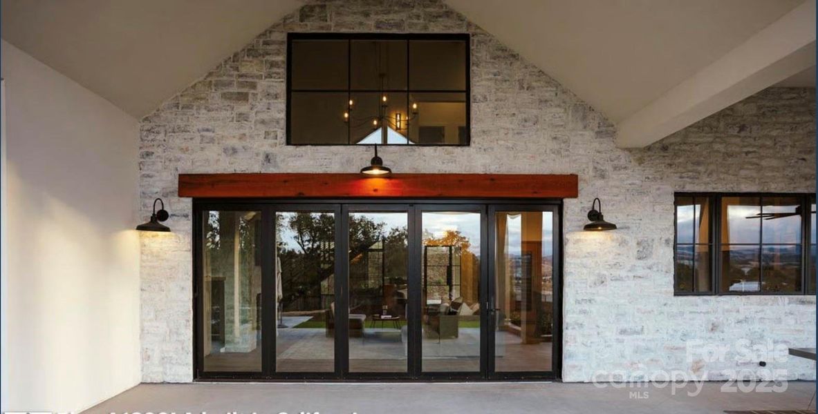 View of Patio Doors Looking from Covered Porch into the Living Room of the Proposed Modern Farmhouse