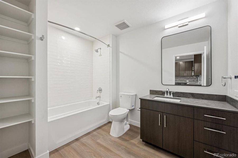 Large Bathroom with Quartz Countertops, Linen Storage & Deep Tub