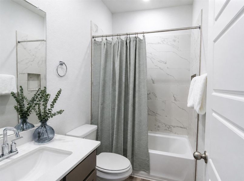 Gleaming stone counters paired with custom tile surround the relaxing bathtub. Gleaming stone counters paired with custom tile surround the relaxing bathtub.