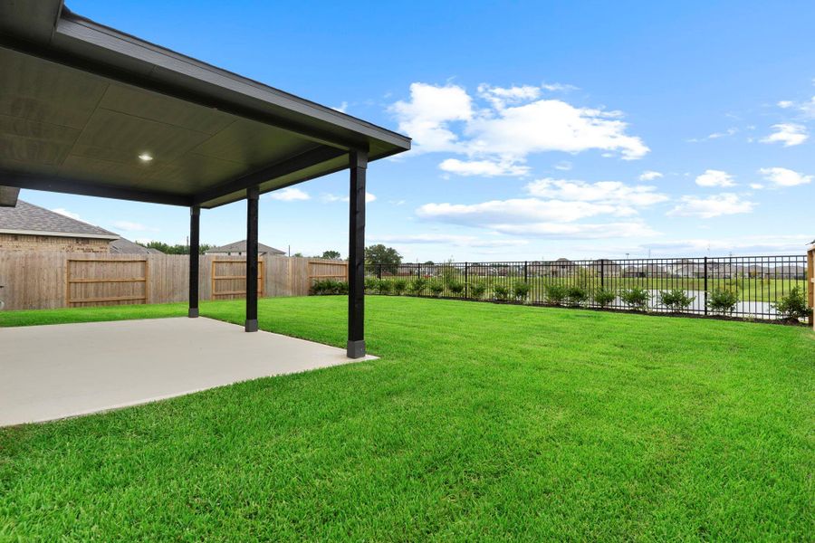 Step outside to the expansive extended covered patio—perfect for outdoor dining, lounging, or entertaining—while enjoying serene views of the open green space beyond the fenced yard. Sprinkler system!