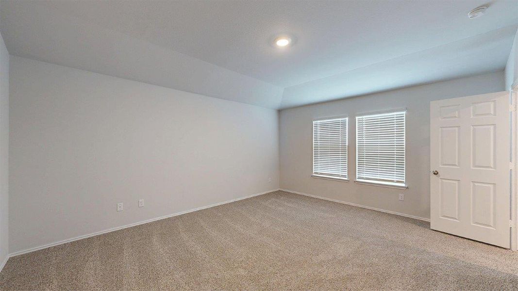 Carpeted room featuring a tray ceiling, recessed lighting, and two windows with blinds Carpeted room featuring a tray ceiling, recessed lighting, and two windows with blinds