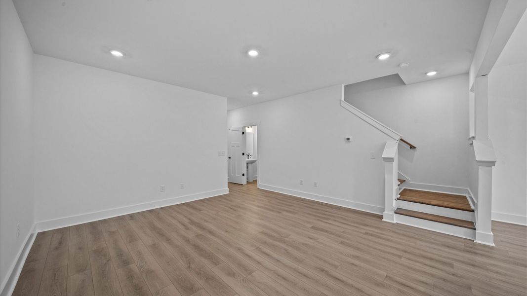 Memorable moments begin in this elegant, open family room with hardwood flooring and refined finishes