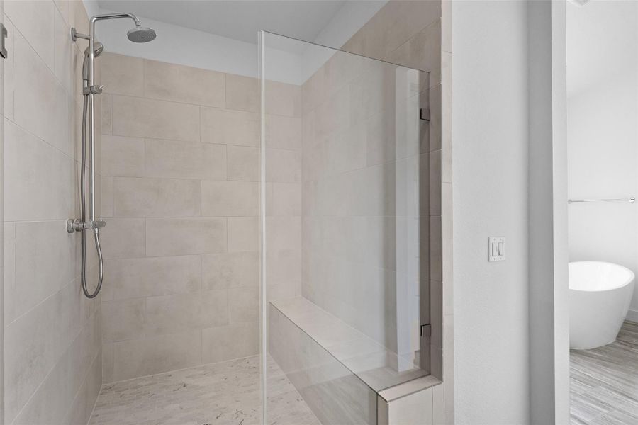 Bathroom with a stall shower and a soaking tub