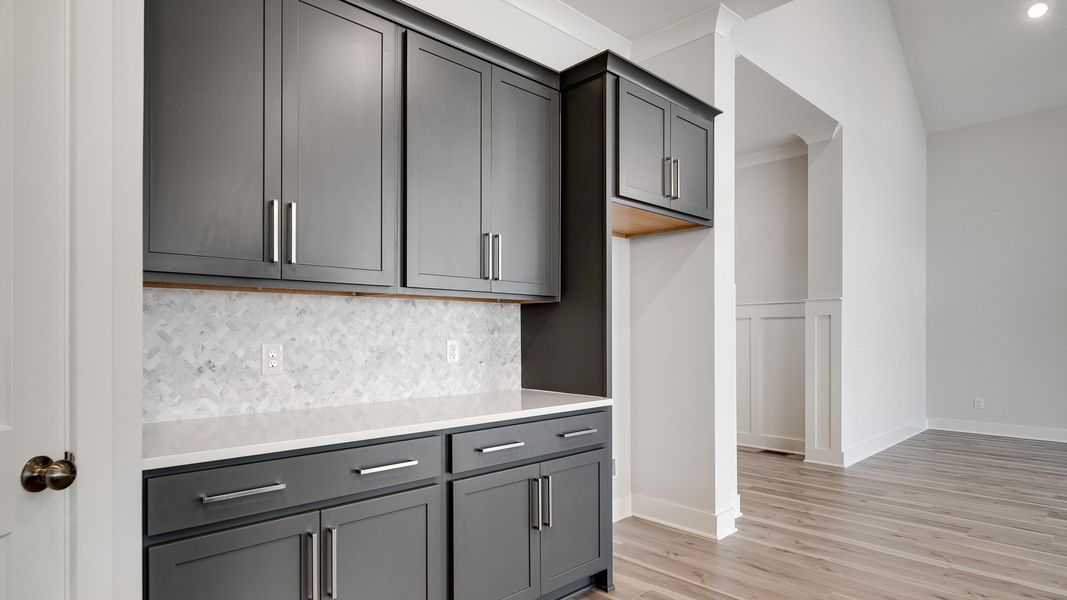 Modern kitchen with island, gray cabinets, and tile backsplash