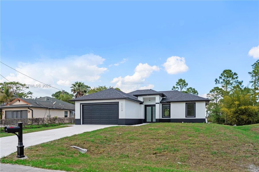 Front exterior of a new home in , Lehigh Acres, FL, highlighting curb appeal (Image 2). Front exterior of a new home in , Lehigh Acres, FL, highlighting curb appeal (Image 2).