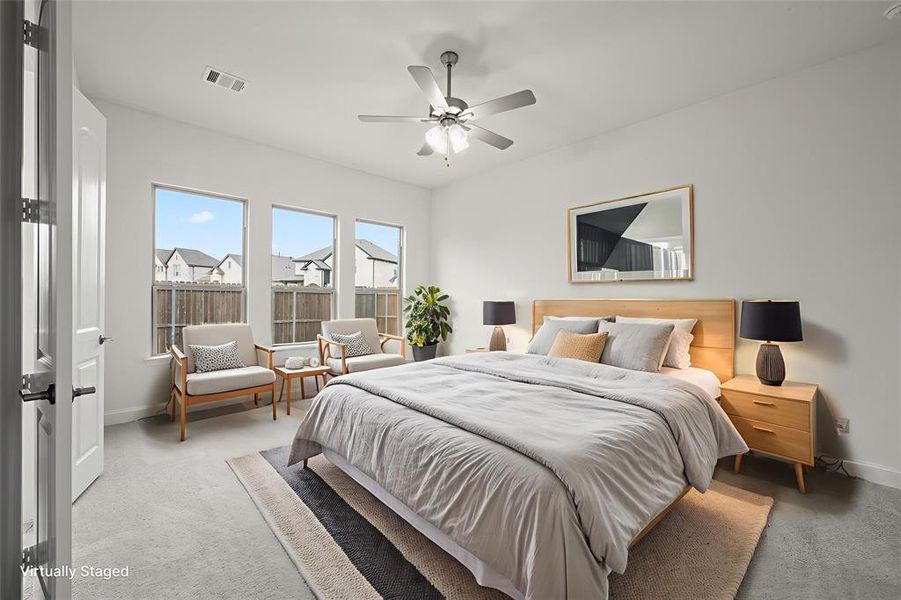 Bedroom with baseboards, ceiling fan, and light carpet Bedroom with baseboards, ceiling fan, and light carpet