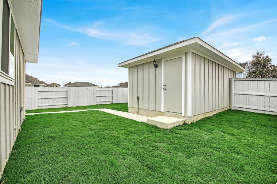 View of shed with a fenced backyard
