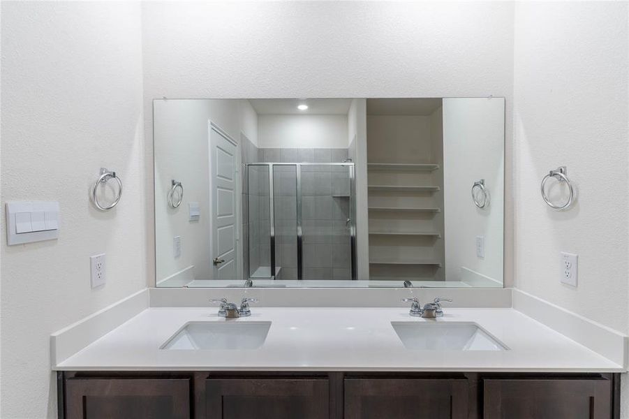 Bathroom featuring vanity and walk in shower