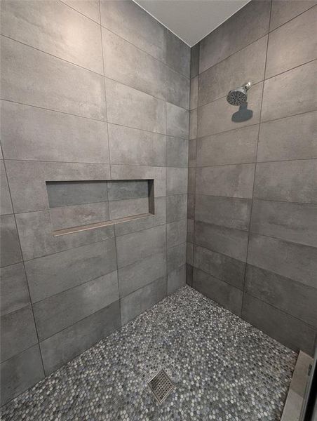 Bathroom featuring a tile shower