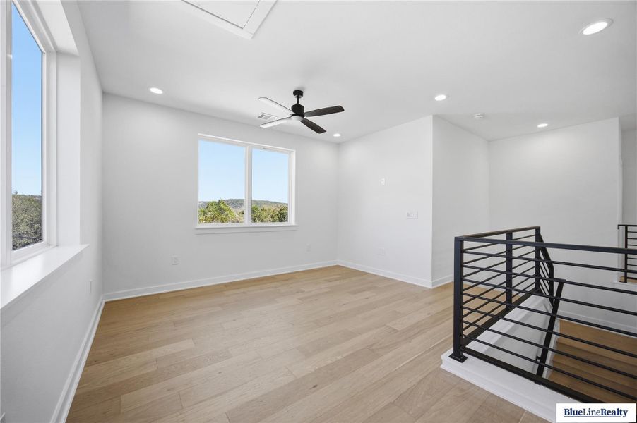 Empty room with light wood-style flooring, a ceiling fan, and recessed lighting