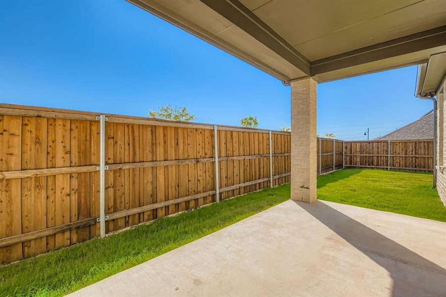 Fenced backyard featuring a patio area