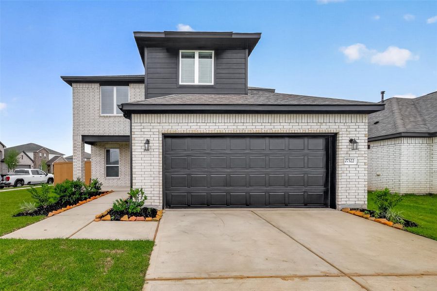 Front exterior of a new home in Sunterra, Katy, TX, highlighting curb appeal (Image 23).