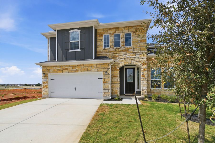 Front exterior of a new home in Santa Rita Ranch, Liberty Hill, TX, highlighting curb appeal (Image 2). Front exterior of a new home in Santa Rita Ranch, Liberty Hill, TX, highlighting curb appeal (Image 2).