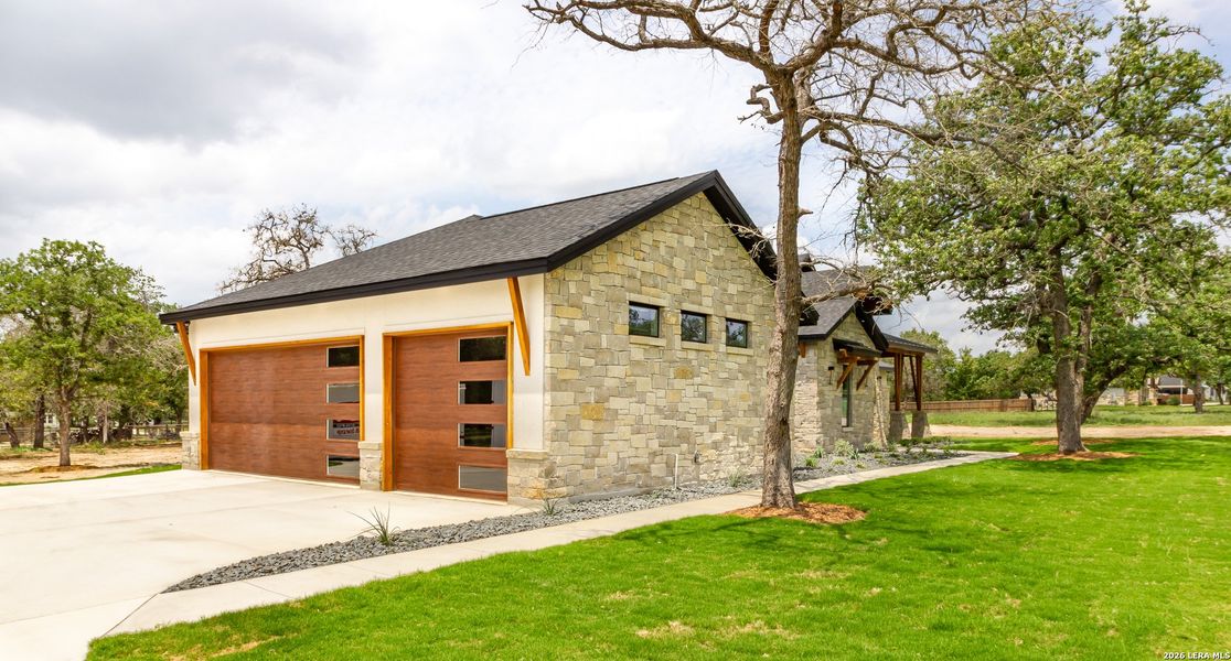 Front exterior of a new home in , Bulverde, TX, highlighting curb appeal (Image 26).