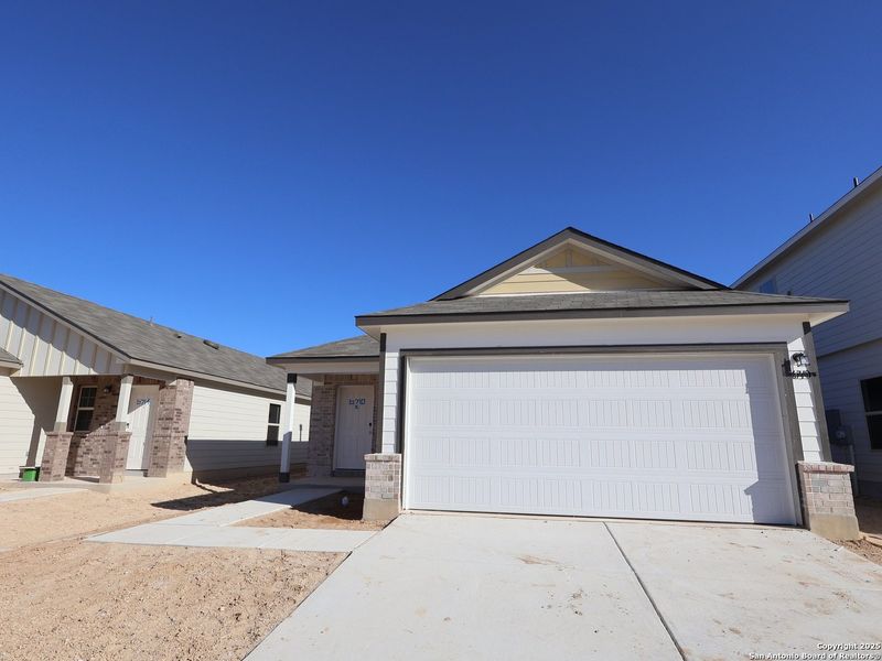 Front exterior of a new home in Winding Brook, San Antonio, TX, highlighting curb appeal (Image 2).