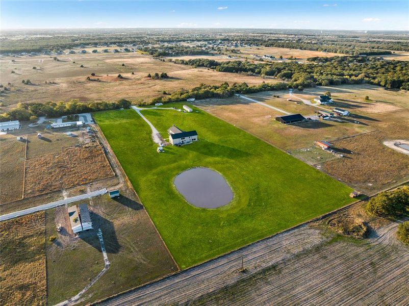 Aerial view of property and surrounding area with rural landscape