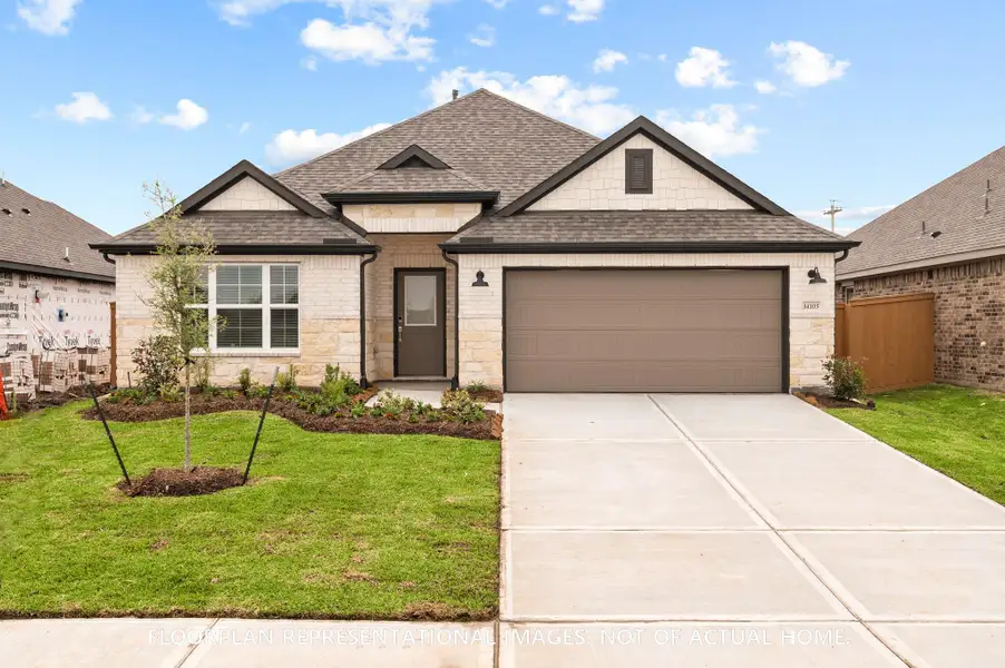 Front exterior of a new home in Pinewood at Grand Texas, New Caney, TX, highlighting curb appeal (Image 15). Front exterior of a new home in Pinewood at Grand Texas, New Caney, TX, highlighting curb appeal (Image 15).