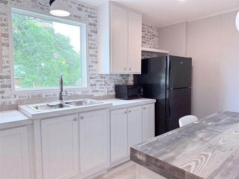 A well-appointed kitchen offers ample counter space, a double sink, and modern appliances.