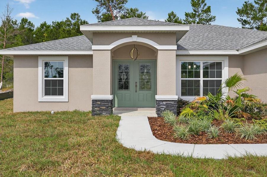 Front exterior of a new home in , Spring Hill, FL, highlighting curb appeal (Image 22).
