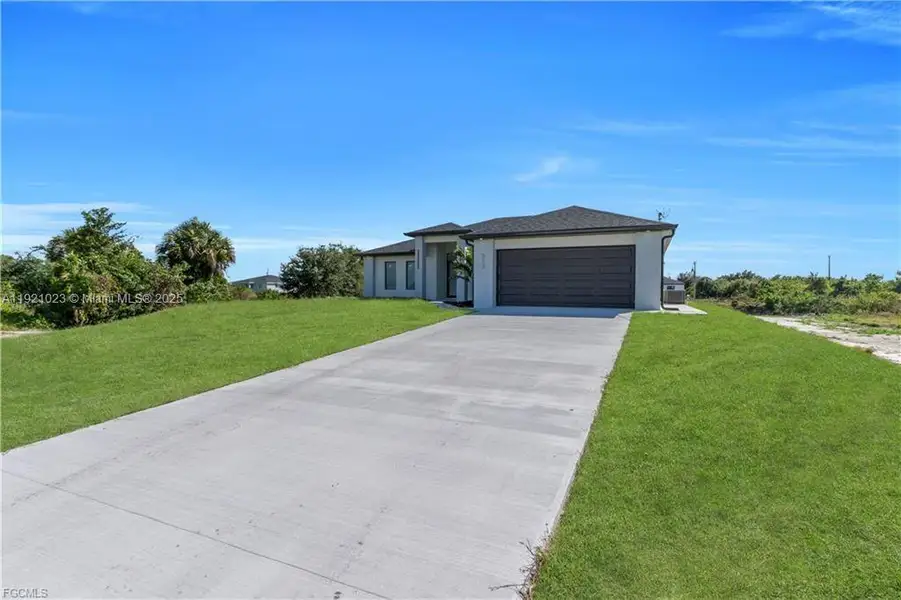 Front exterior of a new home in , Lehigh Acres, FL, highlighting curb appeal (Image 2). Front exterior of a new home in , Lehigh Acres, FL, highlighting curb appeal (Image 2).
