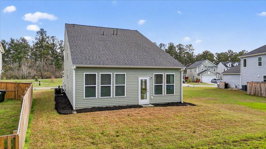 Exterior details and patio area of a home in Jasmine Point at Lakes of Cane Bay, Summerville (Image 26).