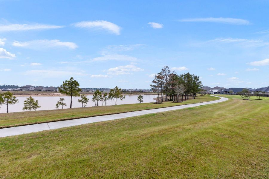 Just past the wrought iron fence is the pond and walking trails. Just past the wrought iron fence is the pond and walking trails.
