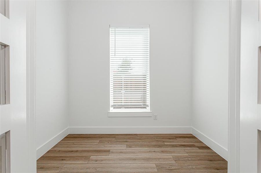 Spare room with light wood-style floors and baseboards