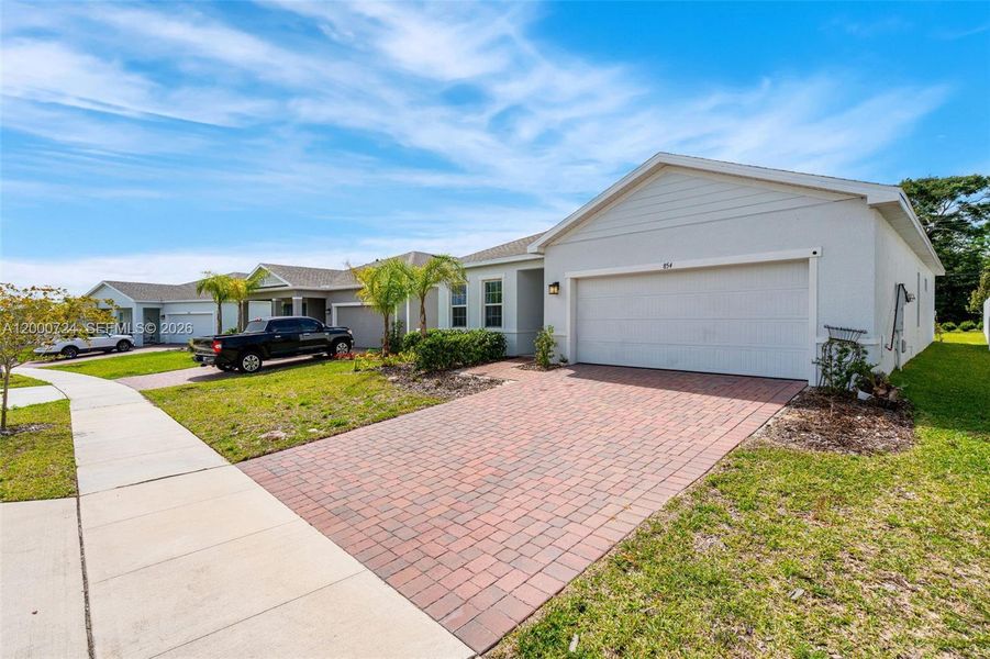 Front exterior of a new home in Brooks Landing, Titusville, FL, highlighting curb appeal (Image 15). Front exterior of a new home in Brooks Landing, Titusville, FL, highlighting curb appeal (Image 15).
