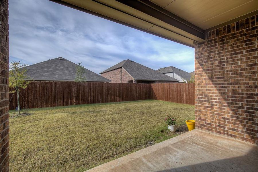 Fenced backyard with a patio area