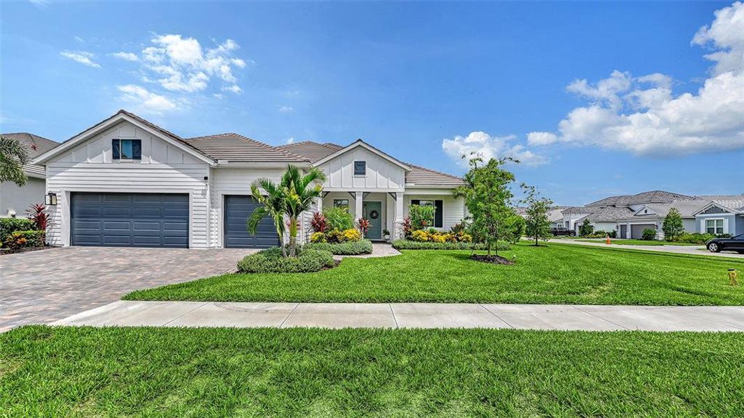 Front exterior of a new home in Windward, Lakewood Ranch, FL, highlighting curb appeal (Image 20). Front exterior of a new home in Windward, Lakewood Ranch, FL, highlighting curb appeal (Image 20).