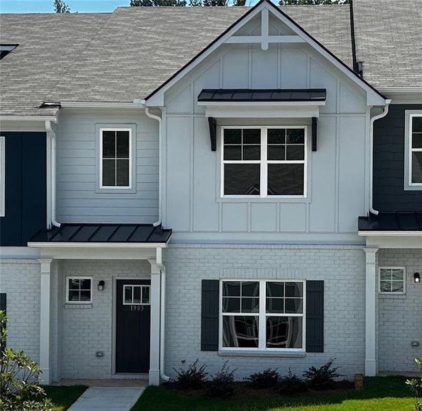 Front exterior of a new home in Shoals Crossing, Conyers, GA, highlighting curb appeal (Image 28). Front exterior of a new home in Shoals Crossing, Conyers, GA, highlighting curb appeal (Image 28).