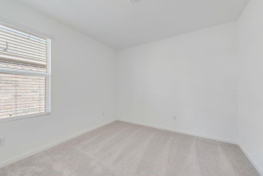 Spare room featuring light colored carpet and baseboards Spare room featuring light colored carpet and baseboards
