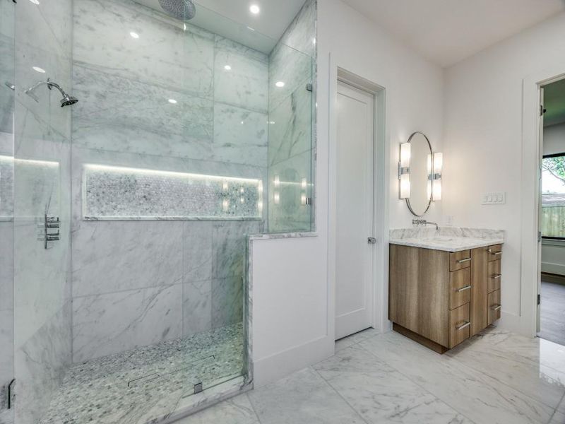 Bathroom featuring vanity and a tile shower