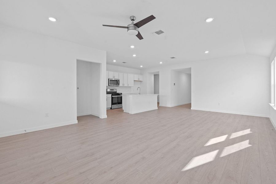 Unfurnished living room featuring recessed lighting, a ceiling fan, and light wood finished floors