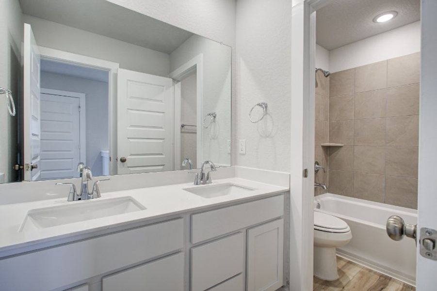 A bathroom with a sink toilet and bathtub. A bathroom with a sink toilet and bathtub.