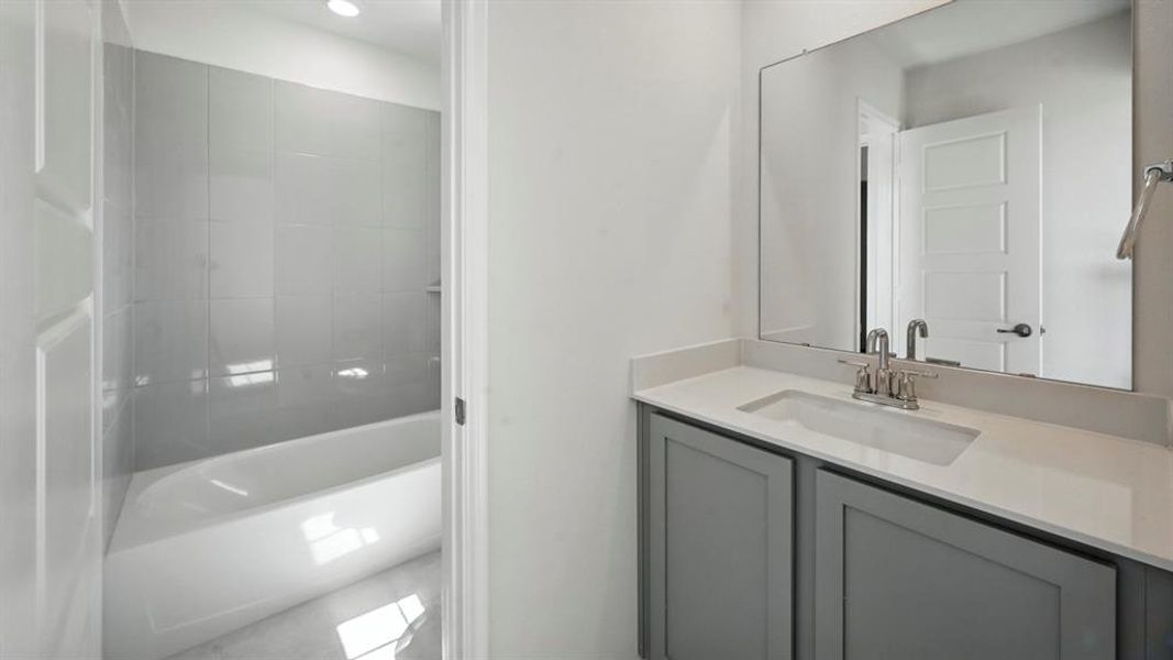 Full bath featuring vanity and a bathtub Full bath featuring vanity and a bathtub