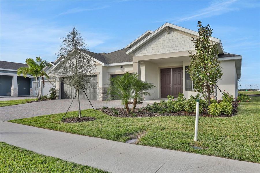 Front exterior of a new home in Seaire, Parrish, FL, highlighting curb appeal (Image 23). Front exterior of a new home in Seaire, Parrish, FL, highlighting curb appeal (Image 23).