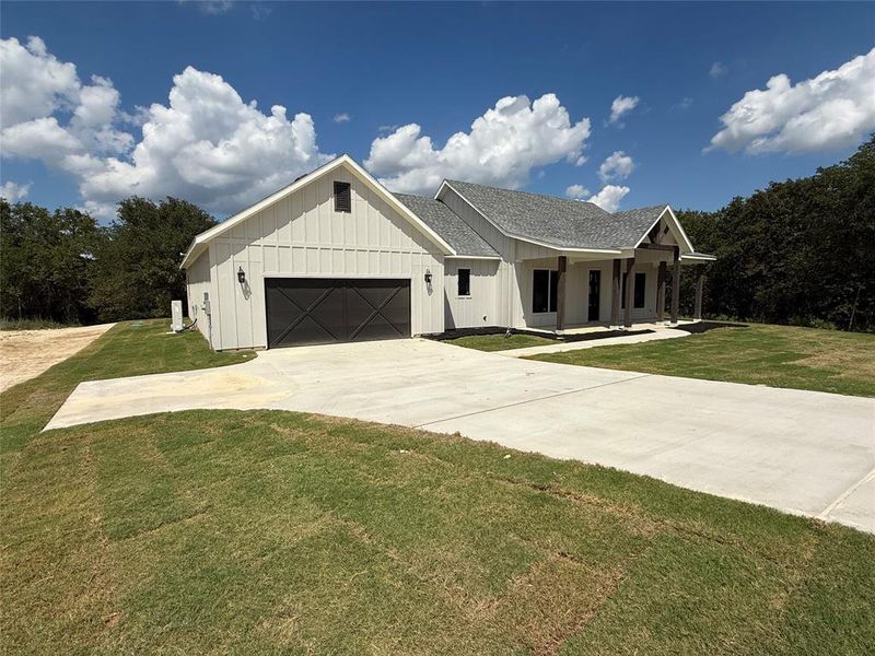 Front exterior of a new home in Zion Trails, Poolville, TX, highlighting curb appeal (Image 1). Front exterior of a new home in Zion Trails, Poolville, TX, highlighting curb appeal (Image 1).